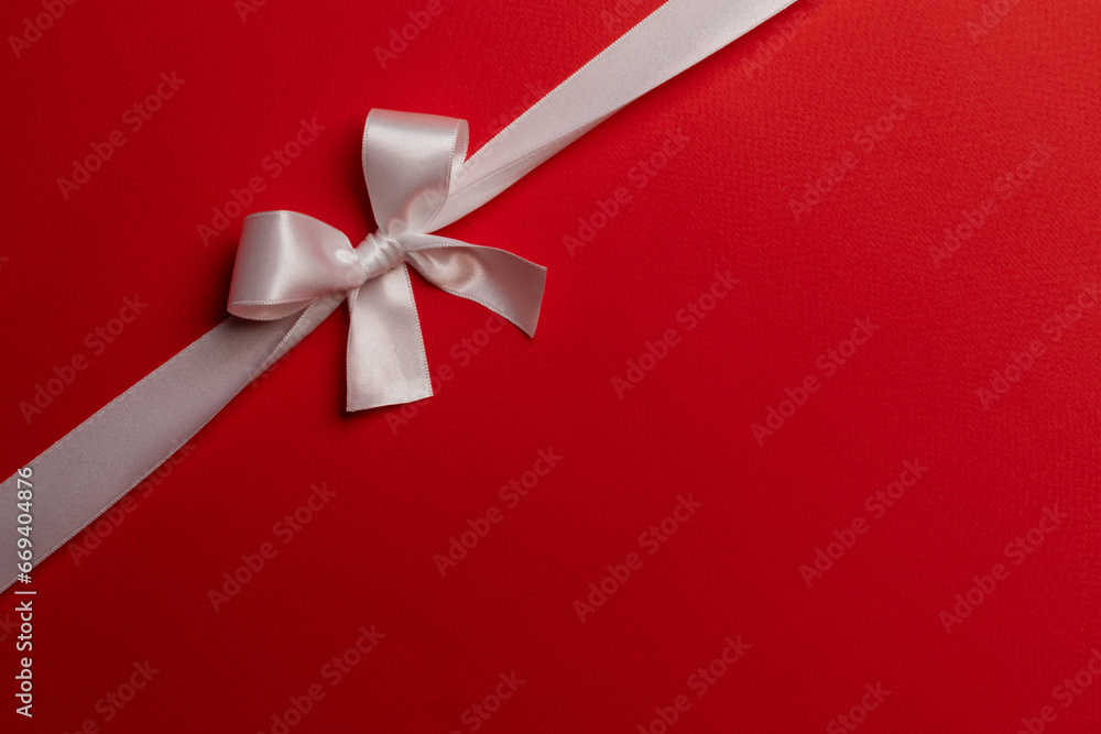 Wall mural white bow on red