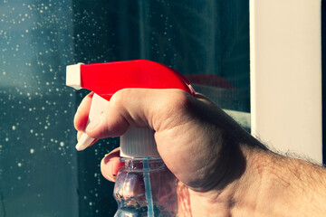 Window washing. Cleaning the window with a brush and foam. The concept of cleanliness and cleaning.
