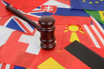 Wooden gavel on many countries national flags 