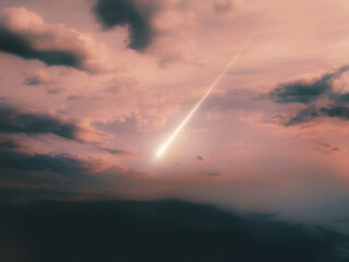 Bright fireball at sunset. Meteor trail against a cloudy sky. Meteorite falling.