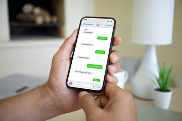 man hands hold phone with app messenger on the screen
