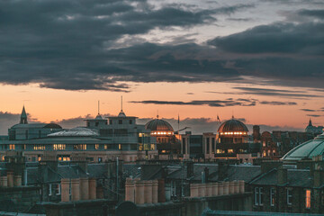 Fototapeta na wymiar Edinburgh a vibrant cityscape illuminated by the setting sun with dramatic clouds overhead