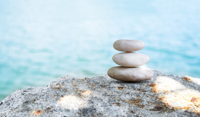 Fototapeta na wymiar Stone Stack Zen Balance on Calm Water Background Sea Spa Stability Concept Template Relax Massage Harmony Peace, Pile Pebble at Coast Ocean Nature Landscape Outdoor.