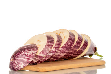 One juicy eggplant cut into pieces on a bamboo kitchen board, macro, isolated on white background.
