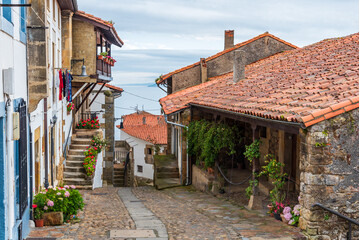 Cobblestone street of old houses in the town of Lastres, overlooking the Cantabrian Sea, Asturias.