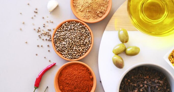 Spices, herbs and powder with top view on table in kitchen for cooking, food or seasoning collection with color. Curry, tumeric or chillies with colorful seeds, cumin and masala on arrangement board