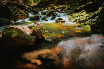 Waterfall or cascade with mountain river along hiking trail