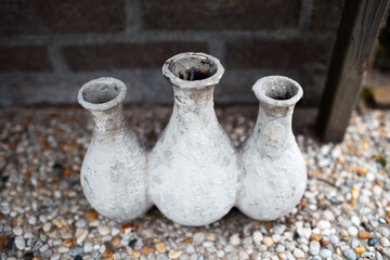 Three ceramic bottle of grey color, close-up view. Clay pitcher.