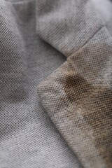 Grey jacket with stain of coffee, closeup