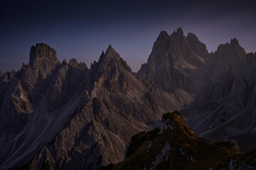 Cadini di Misurina viewpoint illuminated by the moon at night. Dolomites mountains in Italy. Amazing mountain landscape.