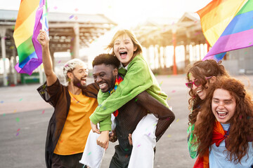 Young diverse alternative friends having fun with LGBT rainbow flags - Inclusive friendly gay...