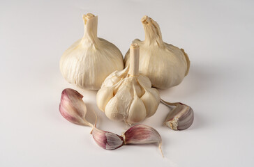 Closeup of three heads of white garlic isolated on a white background
