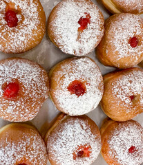 Fresh donuts at bakery display for Hanukkah celebration. 
