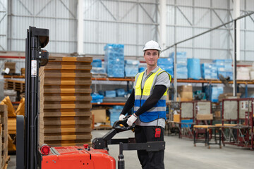 Man worker driver using forklift electric or electric pallet stacker lift moving cardboard boxes...