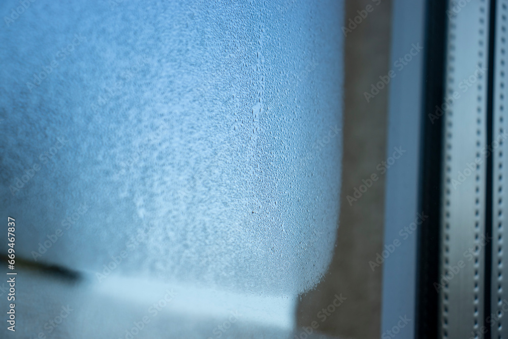Poster moisture condensate on a leaky house window with a distinctive texture.