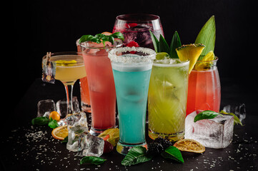 Set of different colored cocktails on the background
