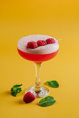Sweet red cocktails with raspberries on a bright background - 669468290