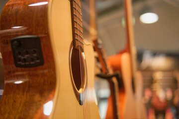 Acoustic guitar in music store, shallow depth of field focus.
