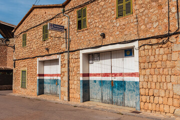 Vintage Weathered Colorful Garage Doors between a Brick Wall
