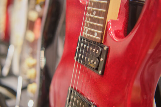 Red electric guitar Farida in a music store. Close-up. Selective focus - Moscow, Russia, September 20, 2023
