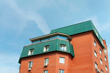 Details of a new constructed red multi-story building. Modern housing construction. Housing stock