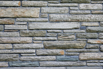 Naklejka premium Background of stone wall gray tone. Different shape dimensions gray stone.