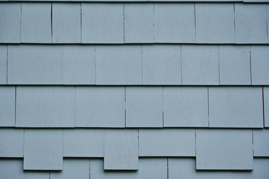 Background of painted gray blue cedar shingle. Exterior wall wood siding.