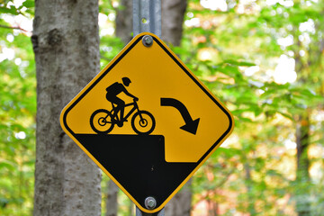 Mountain bike trail, Sudden Drop warning sign, Black and Yellow caution sign.