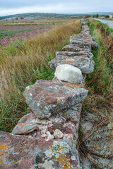 Solid stone wall of medium height that delimits the plots of land in the field