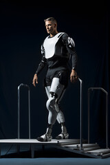 Fototapeta na wymiar Full length portrait of a male robot standing on a platform