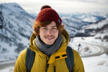 Fototapeta na wymiar A handsome red-haired young man in a knitted hat walks and smiles in a snowy winter mountains. Happy guy's face portrait close-up front view. Generative AI. Outdoor activities concept.