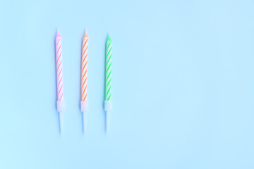 Multicolored birthday candles on blue background, Colorful candles party