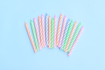 Multicolored birthday candles on blue background, Colorful candles party