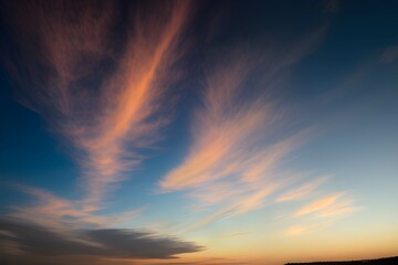美しい夕焼け時の青空にオレンジ色の雲が広がる - 雲の質感はうっすらとしたもの - obrazy, fototapety, plakaty