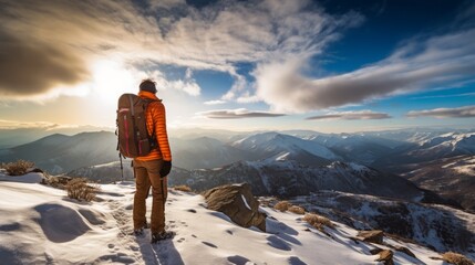 Obraz premium Male tourist went hiking in the mountains in the winter season. Beautiful views of nature. Solo hike. A guy with a big backpacker is traveling. Rear view. Generative AI.