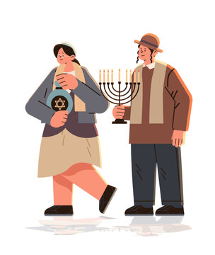 jewish man woman couple in traditional clothes standing together israel people holding jug with david star and candelabrum with candles