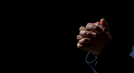 Woman person hand are praying in dark background. Female christian worship to god in faith. Girl christian meditation and pray in christ. Christianity religion concept. - obrazy, fototapety, plakaty