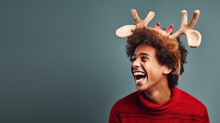 Young man wearing reindeer antlers