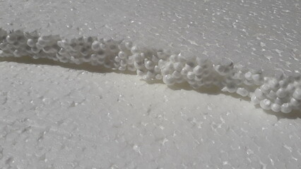 White foam. Insulation. Texture of insulating materials. Light, white background.