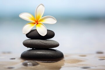 Calm and Relaxation with Spa Stones and Frangipani on Sand