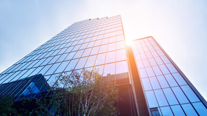 Fototapeta na wymiar Abstract reflection of modern city glass facades. Modern office building detail, glass surface.