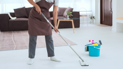 Maid using cleaner equipment in bucket plastic and mop to mopping and cleaning dust on the floor - obrazy, fototapety, plakaty