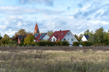 Fototapeta na wymiar landscape with houses and church at the countryside during autumn time