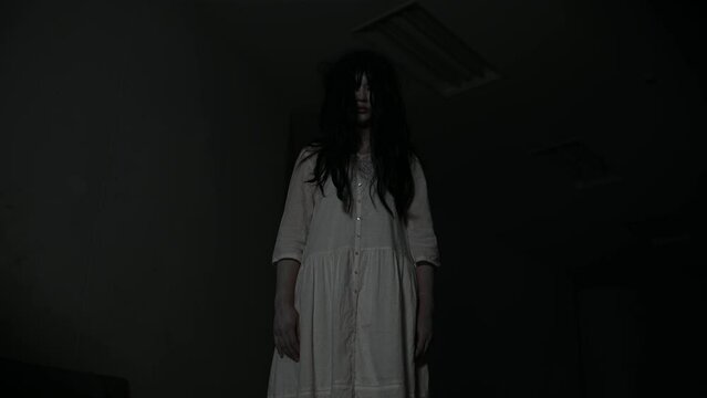 Portrait of asian woman make up ghost,Scary horror scene for background,Halloween festival concept,Ghost movies poster,angry spirit in the apartment