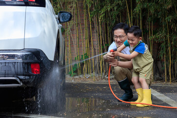 Happy father and son washed the car