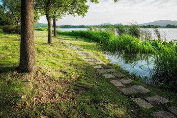Beautiful city park with lake, trees and mountains