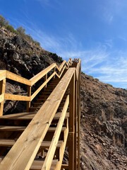 Wooden boardwalk in mountains, stairs in mountains, hiking trail