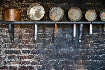 Vintage kitchen utensils on a grunge wall.