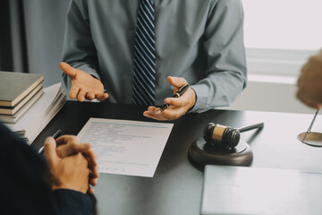 Justice and Law concept. Legal counsel presents to the client a signed contract with gavel and...