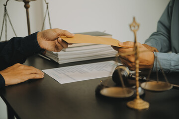 Justice and Law concept. Legal counsel presents to the client a signed contract with gavel and...